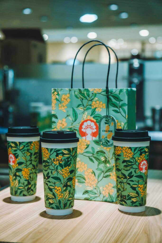 Three coffee cups with green bags on a table